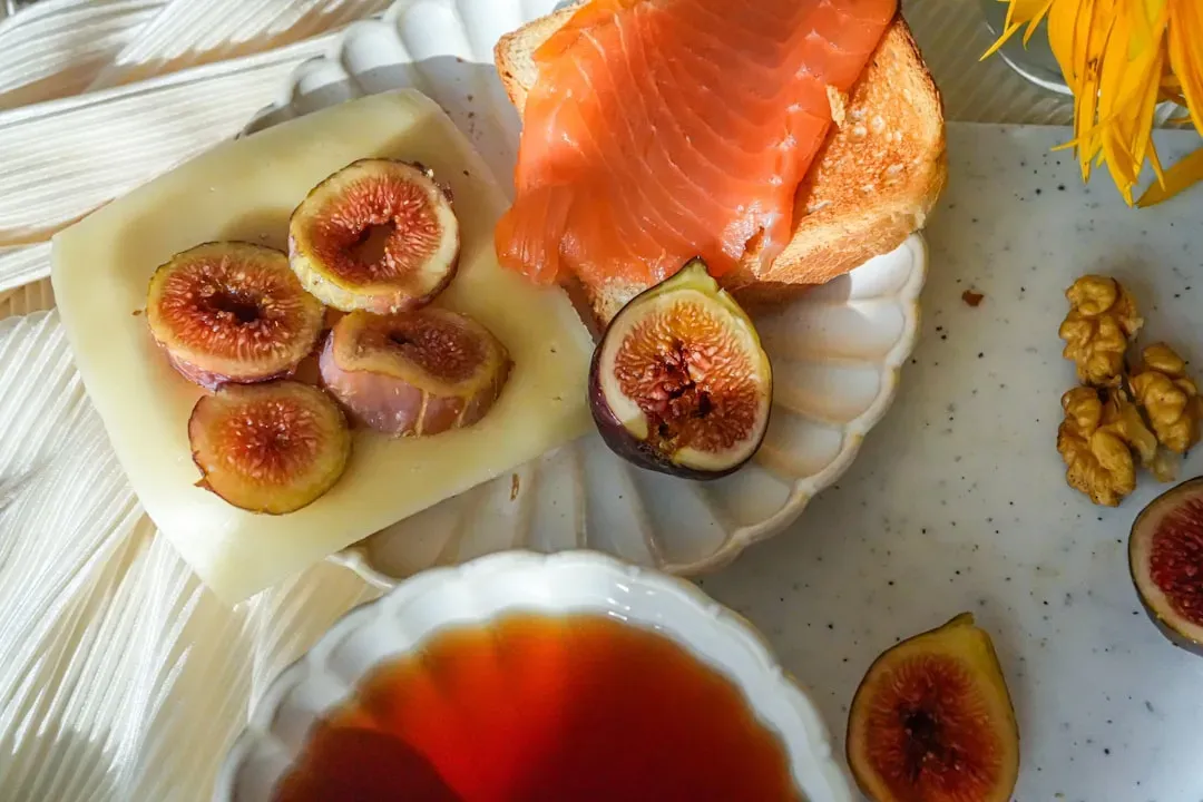 Omega-3 rich foods including salmon, walnuts, flaxseeds, and sardines arranged on wooden board with herbs and lemon for brain