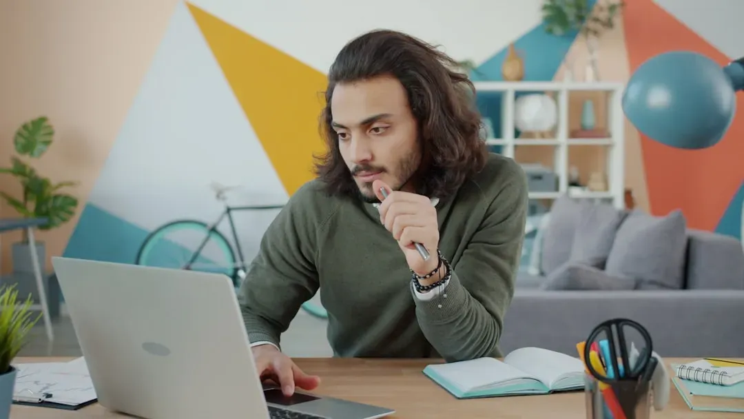 Person studying at desk with books and laptop, demonstrating focus and concentration benefits of nootropic cognitive enhancem