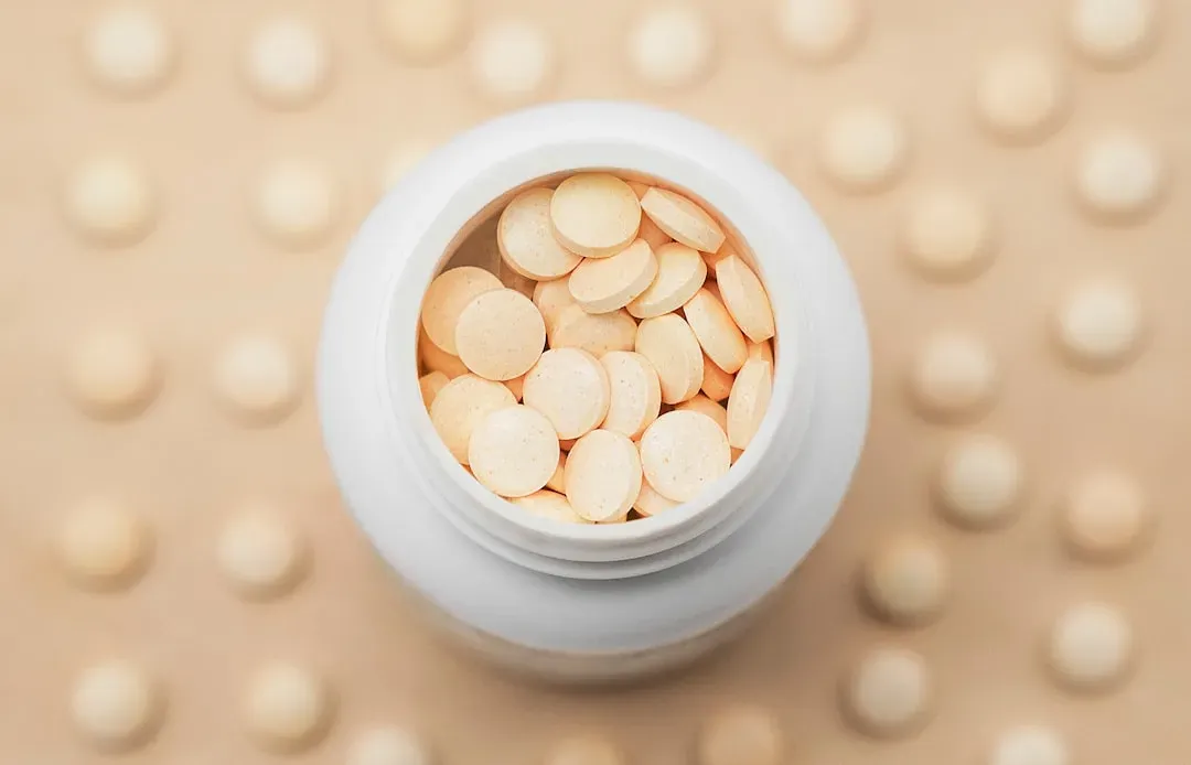 Assorted focus supplement capsules and powders including L-theanine, citicoline, and Bacopa monnieri arranged on light surfac