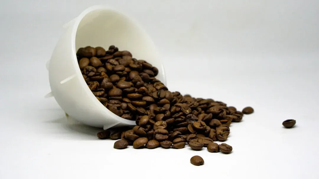 Steaming coffee cup with L-theanine capsules nearby, illustrating the researched caffeine-L-theanine nootropic combination fo