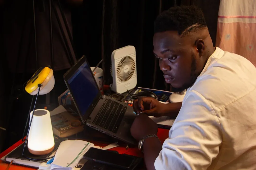 Professional focused on laptop at desk, demonstrating mental clarity and concentration enhanced by nootropic cognitive enhanc